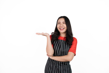 Palm up hands or showing product, Food shop owner concept, Smiling young confident asian woman in black apron and red t-shirt isolated on white background.