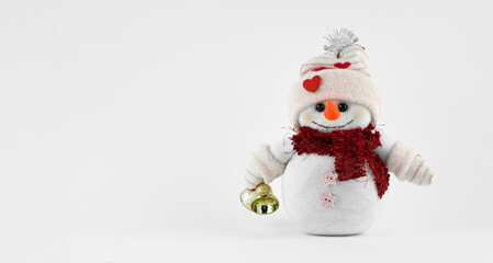 Handmade Cute snowman holding jingle bells on white background