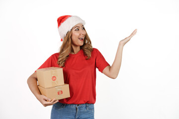 Happy asian woman in santa hat and red t-shirt isolated on white background. holding a box of goods