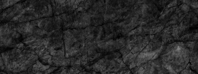 Ancient and grainy Black Emperador marble texture with various cracks, dusty and cracked old wall texture, dark black and grainy Concrete floor or old grunge, old blackboard or chalkboard texture.	