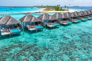 Maldives paradise island. Tropical aerial landscape, seascape water bungalows villas private pools with amazing sea lagoon beach. Exotic tourism destination, summer vacation background. Aerial travel