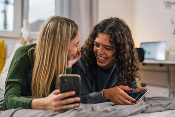 Two young women laugh together