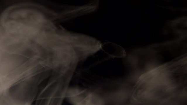 Curling tobacco smoke on a black background close-up