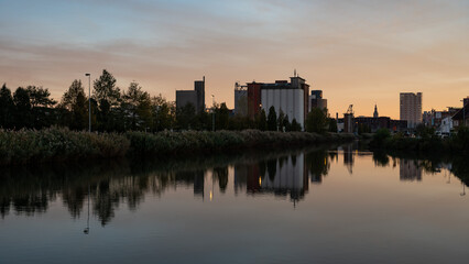 Wilsele, Flemish Brabant, Belgium - Reflection of industrial buildings in the canal during sunset