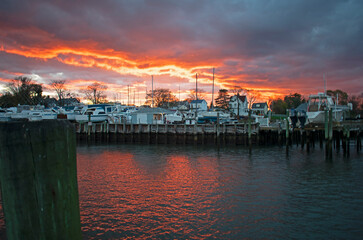 Dramatic sunset at the marina at Keyport, New Jersey, with sun setting through threatening cumulo-nimbus clouds -14