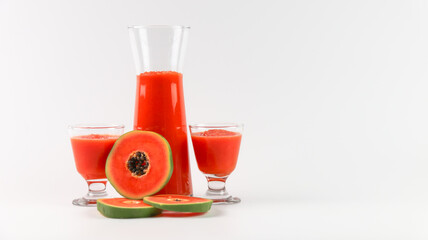Papaya smoothie in glass jar and glasses on white background diet vegetarian healthy and freshness drink concept soft and selective focus