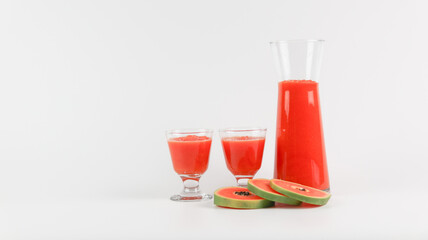 Papaya smoothie in glass jar and glasses on white background diet vegetarian healthy and freshness drink concept soft and selective focus