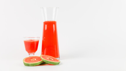 Papaya smoothie in glass jar and glasses on white background diet vegetarian healthy and freshness drink concept soft and selective focus