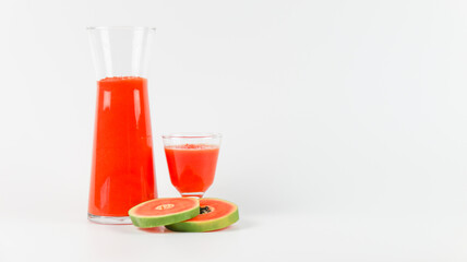 Papaya smoothie in glass jar and glasses on white background diet vegetarian healthy and freshness drink concept soft and selective focus