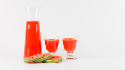 Papaya smoothie in glass jar and glasses on white background diet vegetarian healthy and freshness drink concept soft and selective focus