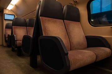 Fototapeta premium comfy seating inside a Dutch train heading to Belgium. 