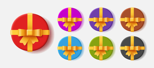 Obraz premium Set of round shaped gift boxes in different colors with golden bow and ribbon