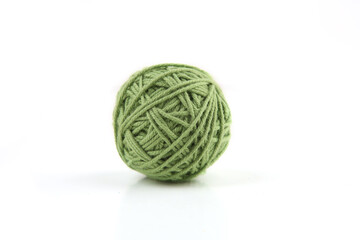 Green cotton thread ball isolated on white background.