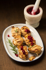 kebab with spices and lingonberry sauce on a dark background