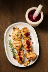 kebab with spices and lingonberry sauce on a dark background, top view