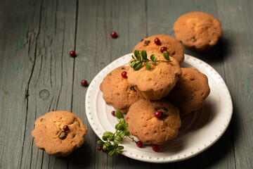 tasty cupcakes with lingonberries on a dark background