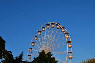 Switzerland, Geneva. Early morning moon and Ferris wheel. August 16, 2022.