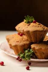 cupcakes with fresh lingonberries dark background