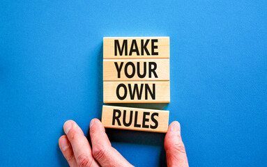 Make your own rules symbol. Concept words Make your own rules on wooden cubes. Beautiful blue table...