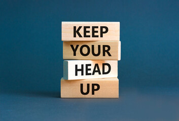 Keep your head up symbol. Concept words Keep your head up on wooden cubes. Beautiful grey table grey background. Business motivational keep your head up concept. Copy space.