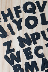 randomly arranged paper letters on a wooden plank