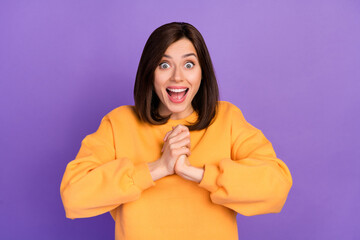 Photo of young adorable pretty cute woman wear orange sweater excited hands together shocked winter sale offer isolated on violet color background