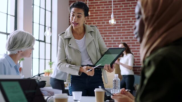Meeting, presentation and training with a business woman using a tablet for team building or coaching. Tablet, research and data with a female leader, manager or boss teaching staff for development