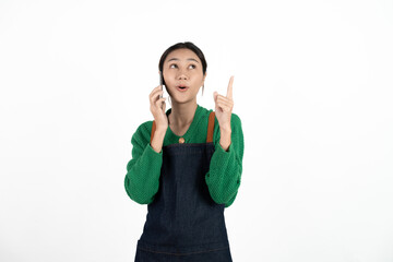 Asian waitress holding the phone with a surprised face isolated on white background.