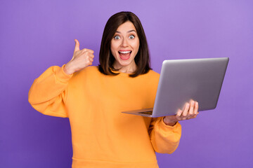 Photo of young adorable cute nice lady wear orange shirt hold new laptop facebook developer...