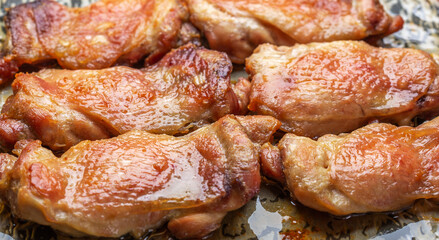 fried chicken meat with appetizing skin in oil