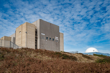 De-commissioned nuclear power generation plant showing is concrete structure and rusted metal...