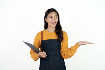 Happy young asian woman business owner wear apron and holding digital tablet for checking order...