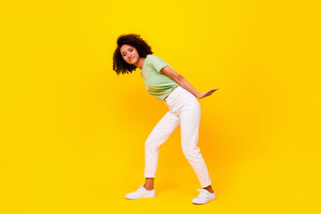 Fototapeta na wymiar Full size photo of young adorable pretty cute funny lady hold hard object difficult problem unhappy isolated on bright yellow color background