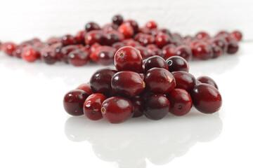 closeup pile of fresh cranberries on white bacle