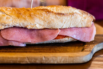 Close up, York ham on a sandwich, on a wooden table
