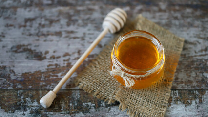 Fresh honey in a jar. Stick for honey. Harvest of honey. Flower honey.
