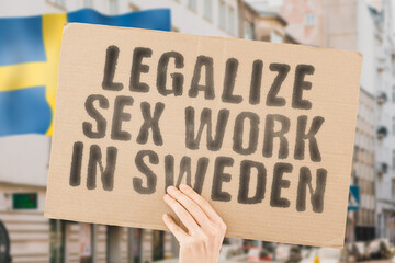 The phrase " Legalize Sex Work in Sweden " is on a banner in men's hands with blurred background. Guide. Govern. Body. Coworker. Crime. Criminal. Democracy. Desire. Employee. Earnings. Dollars