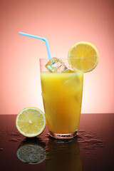 Fruit cocktail with ice cubes and lemon slices on a gradient background