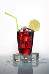 Fruit cocktail with ice and a slice of lemon on a white background