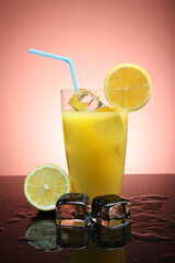 Fruit cocktail with ice cubes and lemon slices on a gradient background