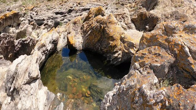 a water puddle on a rocky surface at Pulo do Lobo, M&eacute;rtola, district of Beja, Alentejo, Portugal