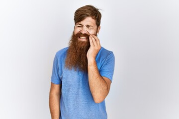 Caucasian man with long bear standing over isolated background touching mouth with hand with painful expression because of toothache or dental illness on teeth. dentist