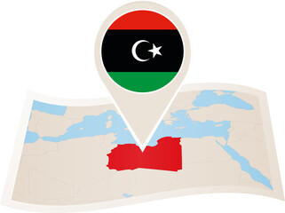 Fototapeta premium Folded paper map of Libya with flag pin of Libya.