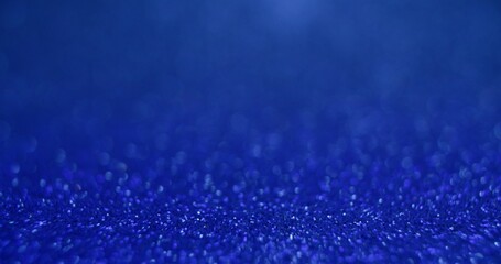 Bokeh light texture. Placement background. Sequin glare. Defocused blue color glowing round sparkles texture on abstract empty space wallpaper.