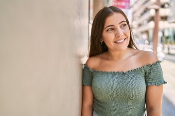 Fototapeta premium Young hispanic girl smiling happy standing at the city.