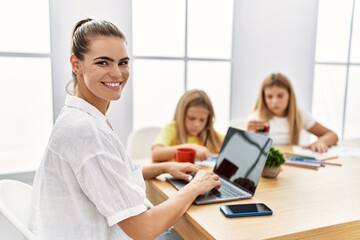 Mother and daughters smiling confident working and drawing at office