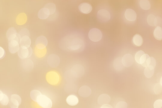 Abstract bokeh background beige colored, natural flare from lights, beige monochromatic photo with optical effect, blurred round bokeh texture as holiday backdrop, celebration wallpaper