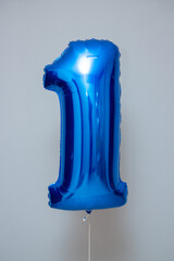 blue balloon foil number one on wall background