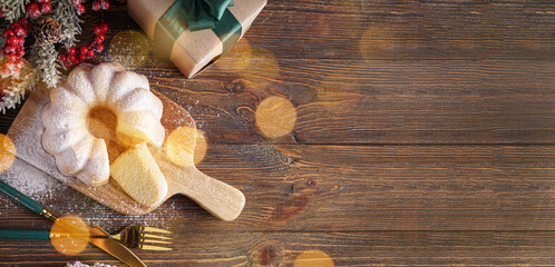 Tasty Christmas cake and decor on wooden background with space for text