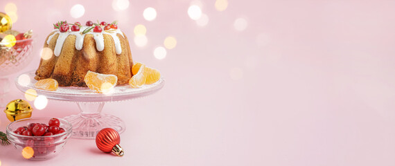 Tasty Christmas cake and decor on pink background with space for text